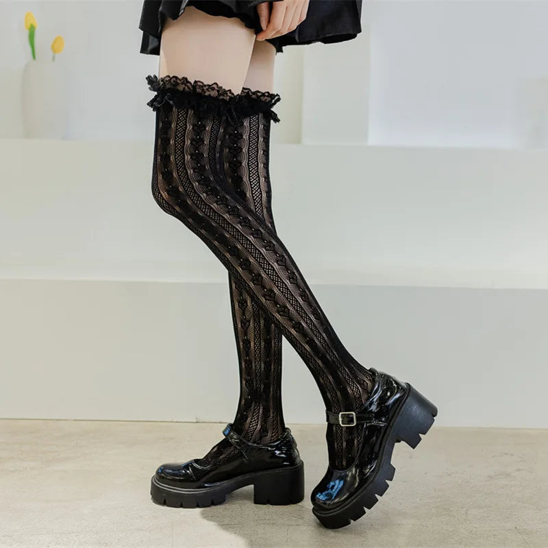 Black heart-pattern fishnet thigh-highs with platform boots